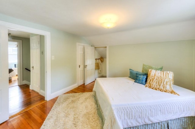 197 Eastern Ave, Worcester, MA 01605 - bedroom featuring vaulted ceiling, wood finished floors, and baseboards