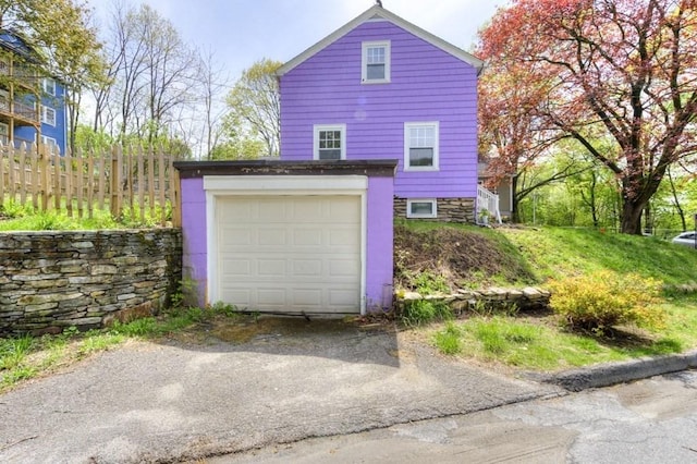 197 Eastern Ave, Worcester, MA 01605 - garage featuring fence and driveway