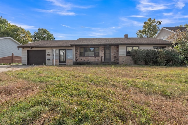 single story home featuring a front lawn and a garage