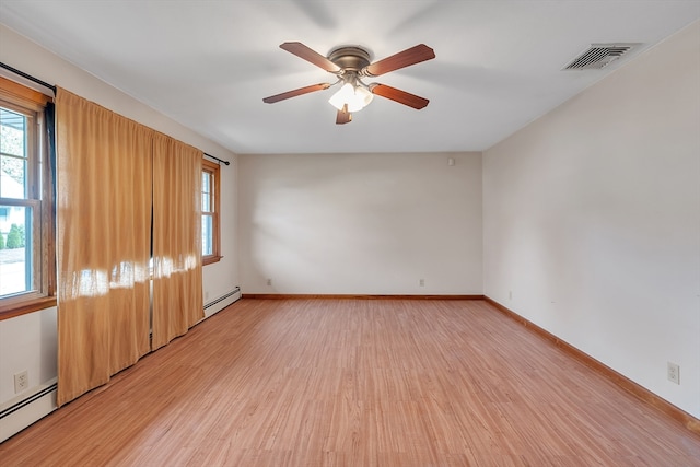 unfurnished room featuring a baseboard heating unit, light wood-type flooring, and ceiling fan