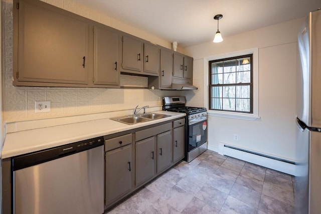 kitchen featuring stainless steel appliances, gray cabinetry, a baseboard radiator, pendant lighting, and sink