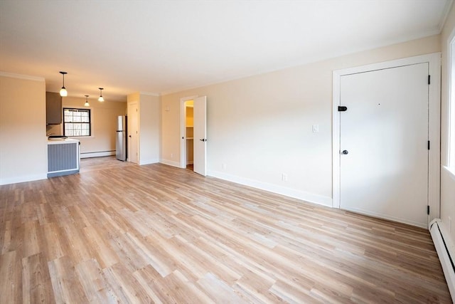 unfurnished living room featuring light wood-type flooring and baseboard heating