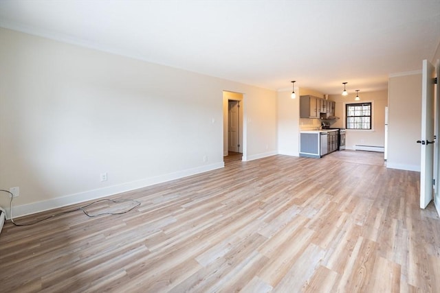 unfurnished living room featuring a baseboard heating unit and light hardwood / wood-style floors