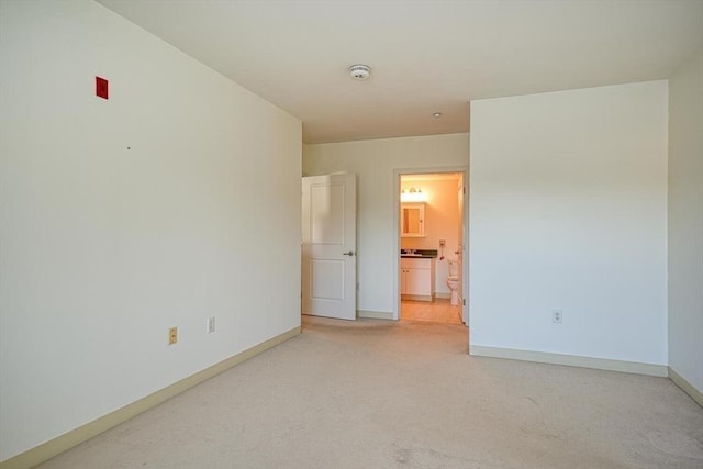 unfurnished bedroom with carpet floors and connected bathroom