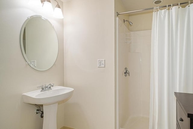 bathroom featuring walk in shower and sink