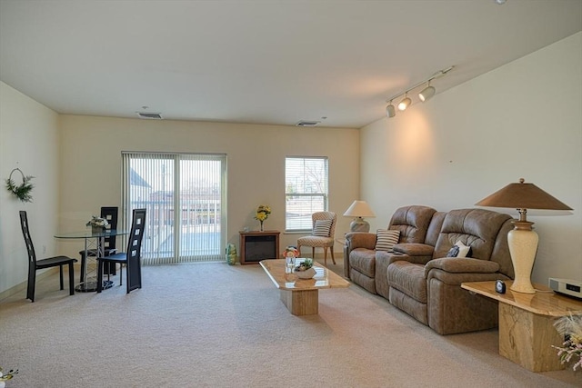 living room featuring light carpet and track lighting