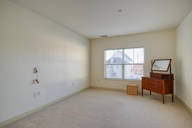 unfurnished room with light carpet