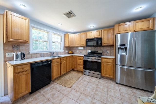 32 Eaton Rd W, Framingham, MA 01701 - kitchen with black appliances, light countertops, decorative backsplash, and light tile patterned floors