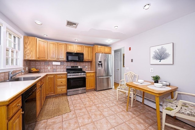 32 Eaton Rd W, Framingham, MA 01701 - kitchen with black appliances, tasteful backsplash, light countertops, and light tile patterned flooring