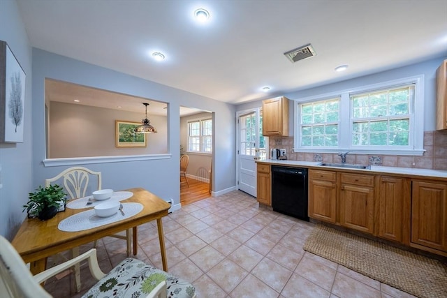 32 Eaton Rd W, Framingham, MA 01701 - kitchen with dishwasher, decorative backsplash, light countertops, light tile patterned flooring, and brown cabinetry