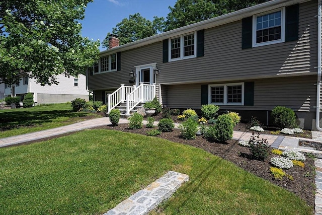 32 Eaton Rd W, Framingham, MA 01701 - bi-level home featuring a chimney and a front yard