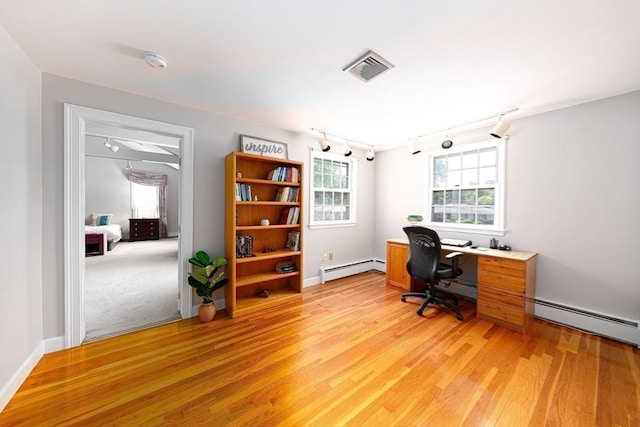 32 Eaton Rd W, Framingham, MA 01701 - office area featuring track lighting, a baseboard heating unit, and light wood finished floors