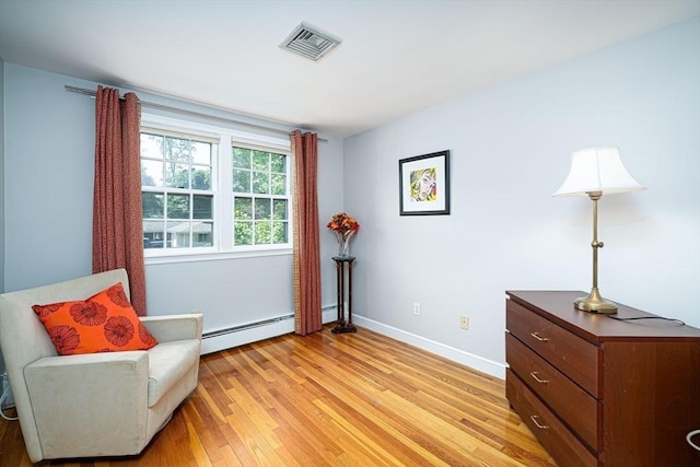 32 Eaton Rd W, Framingham, MA 01701 - living area with baseboard heating and light wood finished floors