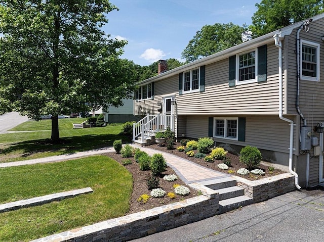 32 Eaton Rd W, Framingham, MA 01701 - bi-level home with a chimney and a front lawn