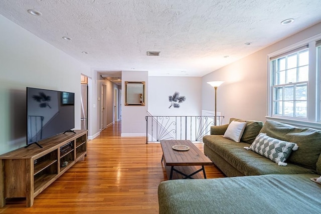 32 Eaton Rd W, Framingham, MA 01701 - living room featuring light wood-style floors, a textured ceiling, and recessed lighting