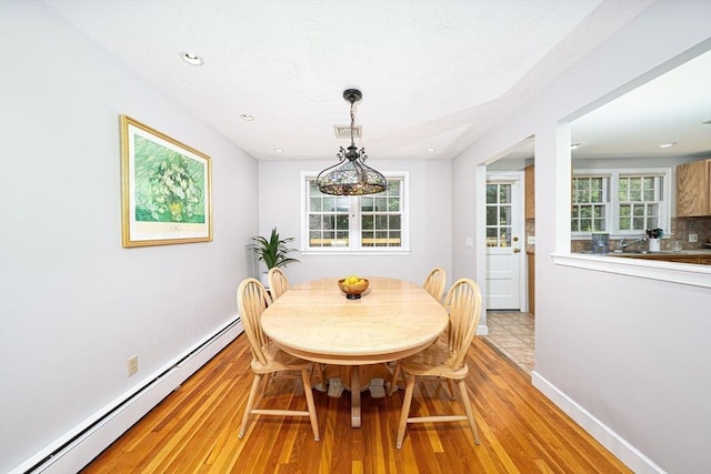 32 Eaton Rd W, Framingham, MA 01701 - dining room with a baseboard radiator, light wood-style floors, and recessed lighting