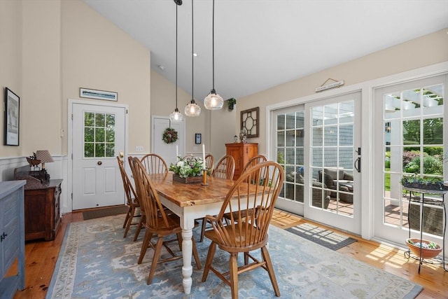 5 Putnam Ave, Barnstable, MA 02635 - dining room featuring light wood finished floors, a wainscoted wall, and high vaulted ceiling