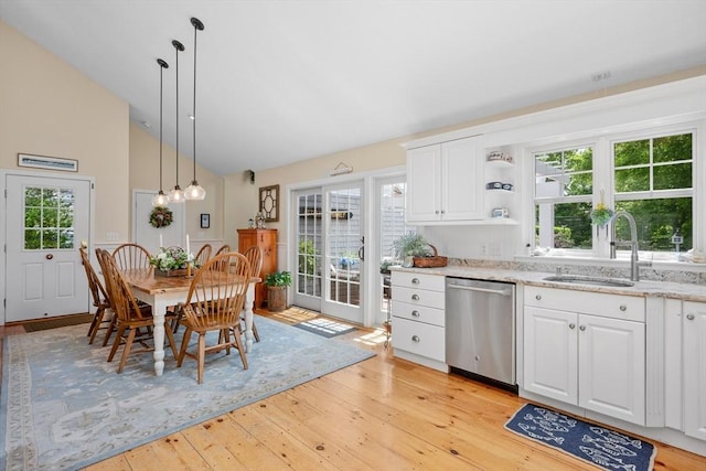 5 Putnam Ave, Barnstable, MA 02635 - kitchen featuring stainless steel dishwasher, light wood-style flooring, white cabinets, light stone counters, and decorative light fixtures