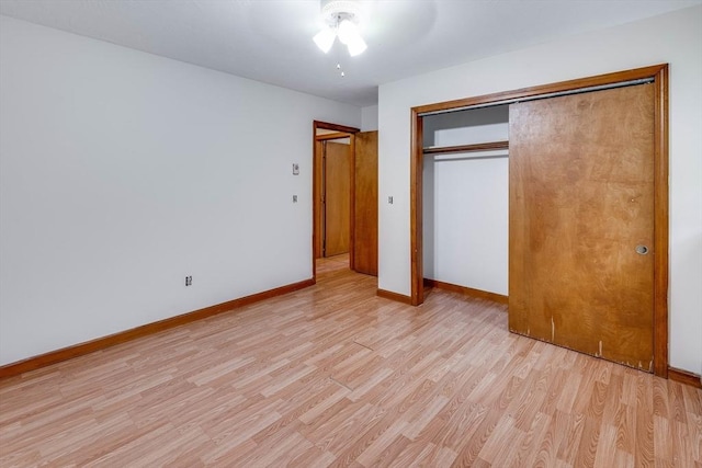 unfurnished bedroom with a closet, ceiling fan, and light wood-type flooring