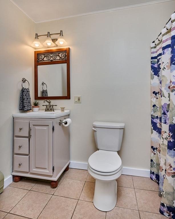 18 Coombs Hill Rd, Colrain, MA 01340 - full bathroom with toilet, vanity, baseboards, tile patterned floors, and crown molding