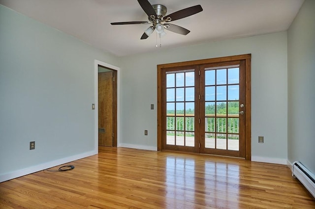 18 Coombs Hill Rd, Colrain, MA 01340 - spare room with a baseboard heating unit, light wood-style flooring, baseboards, ceiling fan, and french doors
