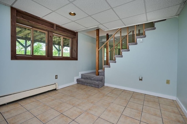 18 Coombs Hill Rd, Colrain, MA 01340 - below grade area featuring stairs, a drop ceiling, a baseboard radiator, tile patterned flooring, and baseboards
