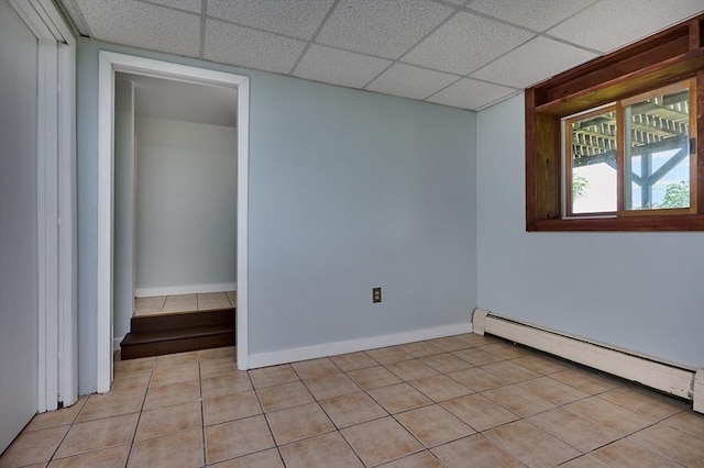 18 Coombs Hill Rd, Colrain, MA 01340 - unfurnished room with a baseboard heating unit, a drop ceiling, light tile patterned floors, and baseboards