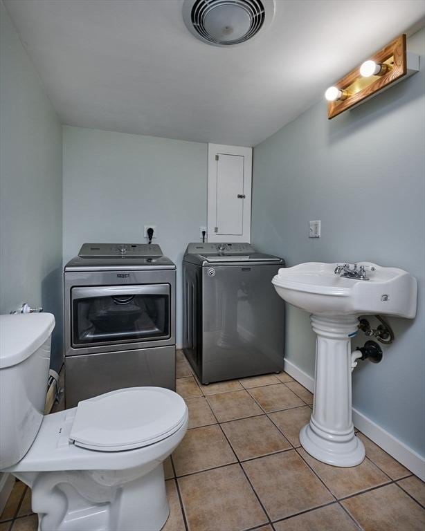 18 Coombs Hill Rd, Colrain, MA 01340 - bathroom featuring washer and dryer, toilet, tile patterned flooring, and baseboards