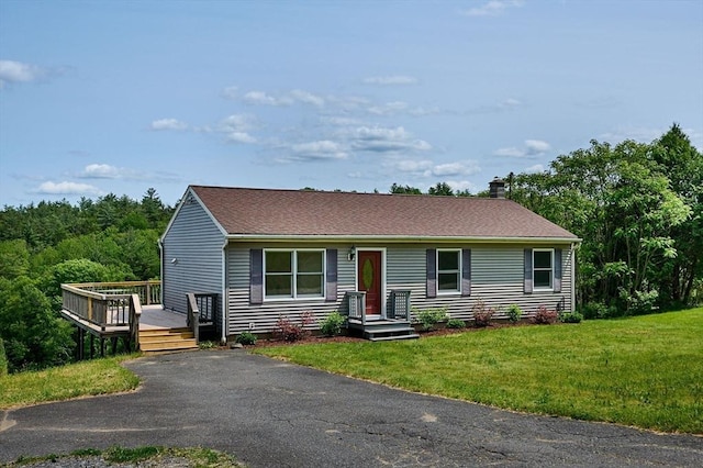 18 Coombs Hill Rd, Colrain, MA 01340 - view of front of property with a wooden deck, a front lawn, a chimney, and roof with shingles