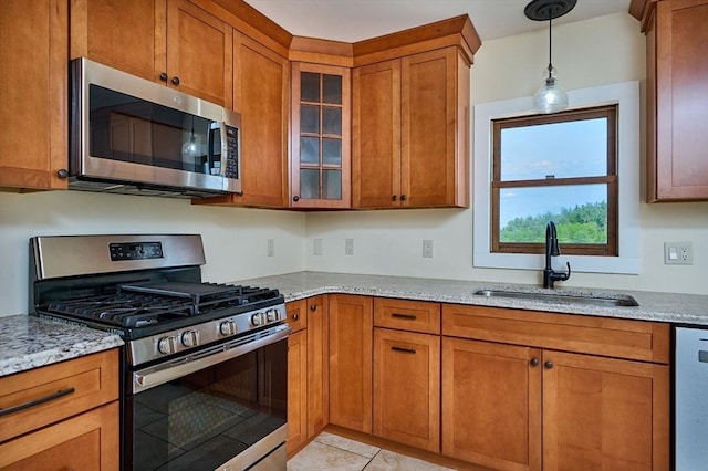 18 Coombs Hill Rd, Colrain, MA 01340 - kitchen featuring appliances with stainless steel finishes, a sink, brown cabinets, light stone counters, and glass insert cabinets