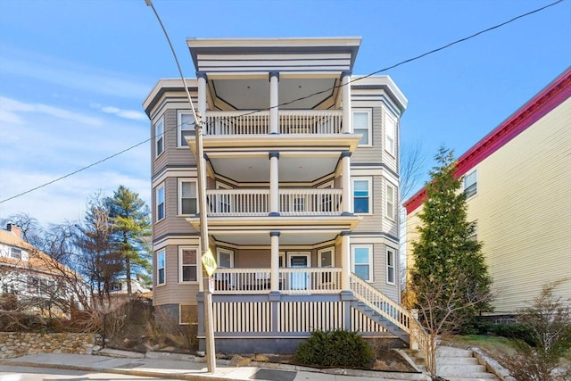 view of front of house with covered porch and a balcony