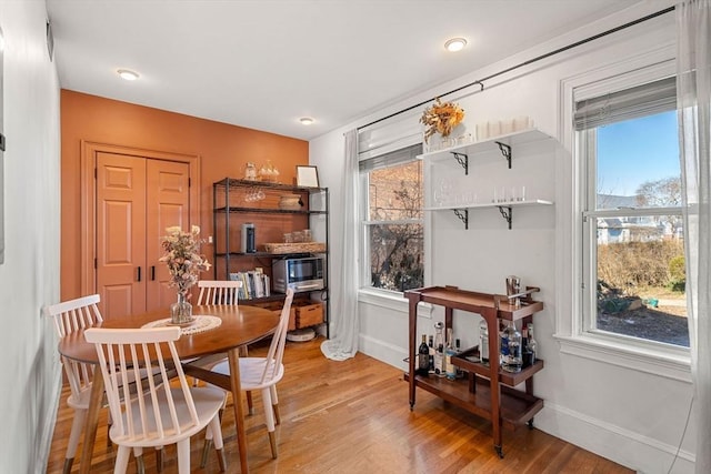 dining room with light wood-style flooring and baseboards