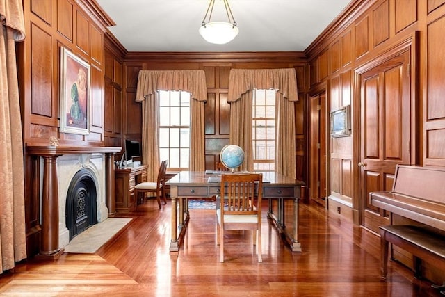 home office featuring a fireplace with flush hearth, ornamental molding, and a decorative wall