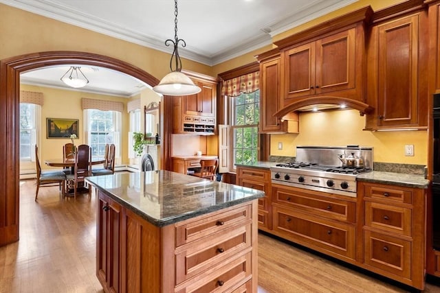 kitchen with brown cabinetry, light wood-style floors, and stainless steel gas cooktop