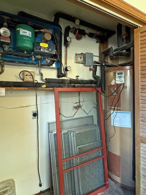 utility room featuring water heater