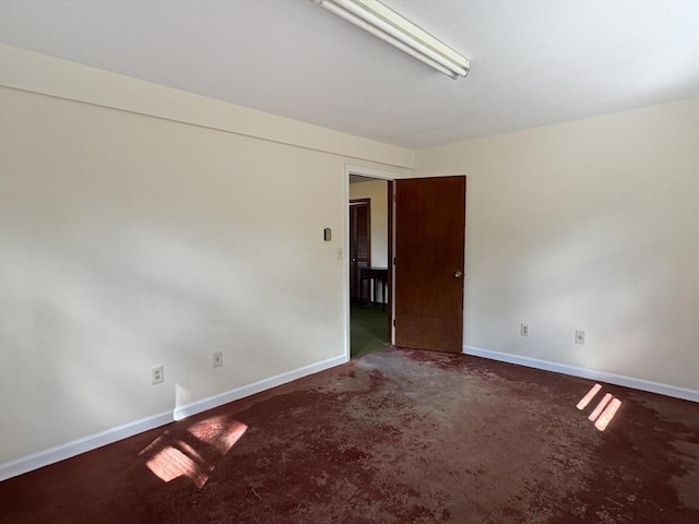 spare room featuring baseboards