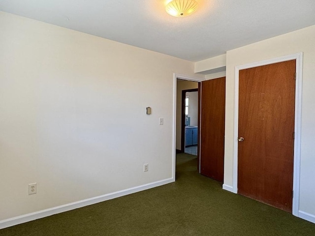 unfurnished bedroom with carpet, baseboards, and a closet