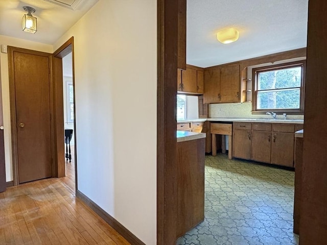 kitchen with light countertops and brown cabinetry