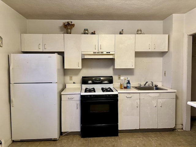 kitchen with a textured ceiling, white fridge, gas stove, white cabinets, and sink