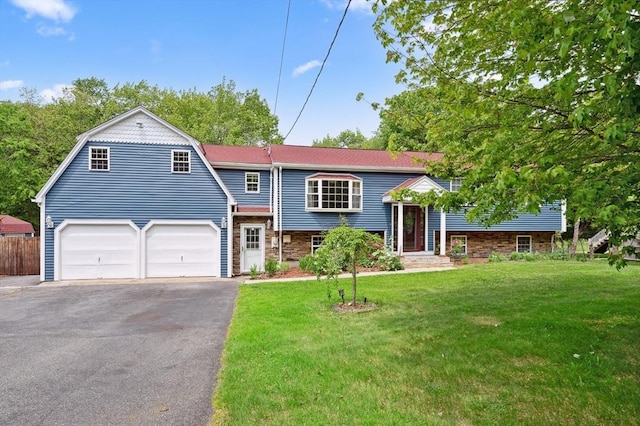 451 Lincoln St, Abington, MA 02351 - view of front of property with driveway, an attached garage, stone siding, and a gambrel roof