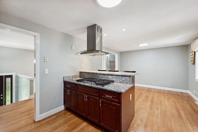 451 Lincoln St, Abington, MA 02351 - kitchen with island exhaust hood, stainless steel gas cooktop, a peninsula, light wood-type flooring, and baseboards
