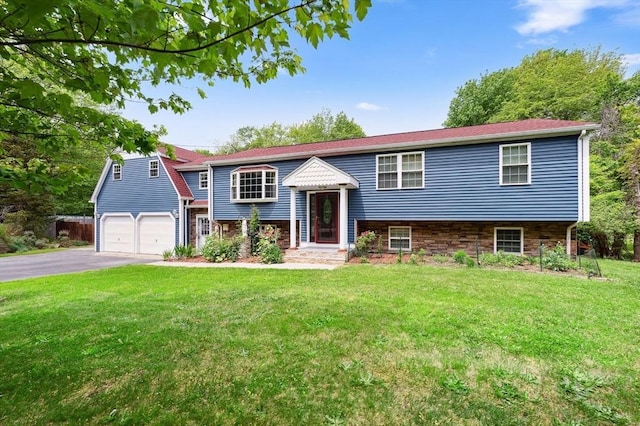 451 Lincoln St, Abington, MA 02351 - split foyer home featuring asphalt driveway, a front yard, and a garage