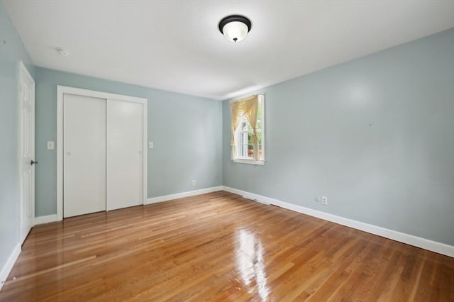 451 Lincoln St, Abington, MA 02351 - unfurnished bedroom with a closet, wood finished floors, and baseboards