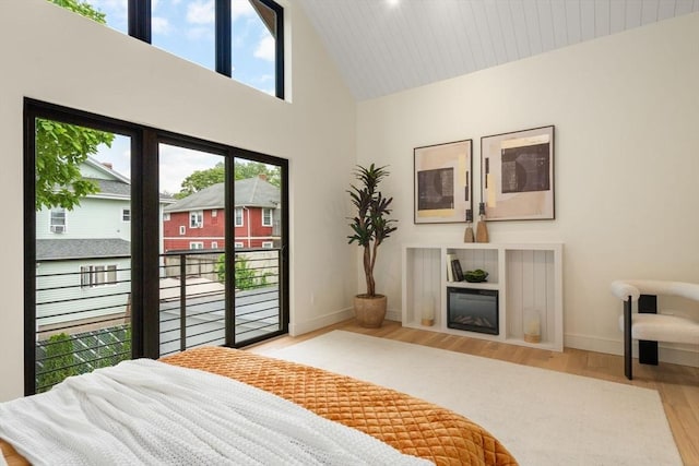 33 Conwell Ave, Somerville, MA 02144 - bedroom featuring access to exterior, wood finished floors, and high vaulted ceiling