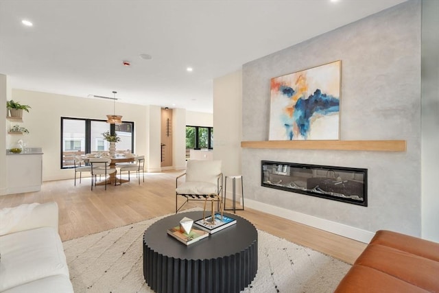 33 Conwell Ave, Somerville, MA 02144 - living area with a glass covered fireplace, wood finished floors, and recessed lighting