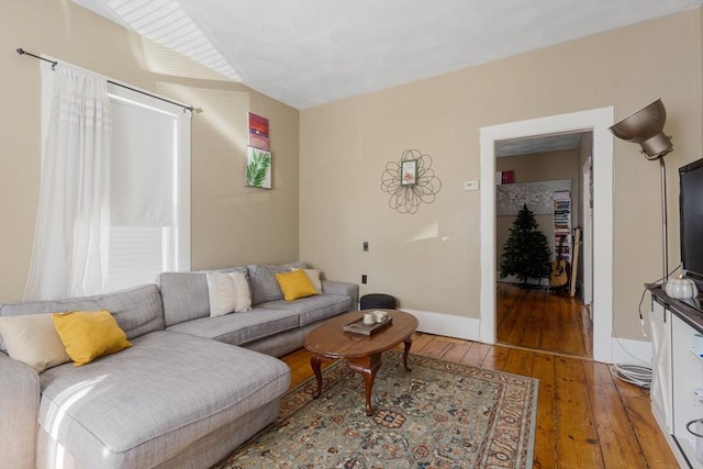 living area with baseboards and light wood finished floors