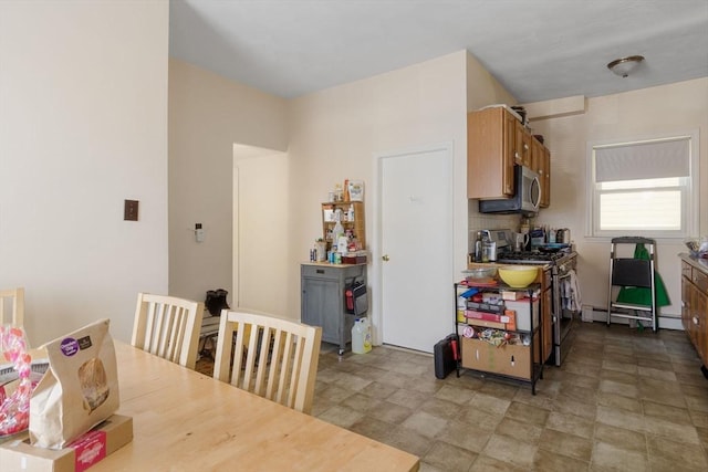 kitchen featuring baseboard heating and appliances with stainless steel finishes