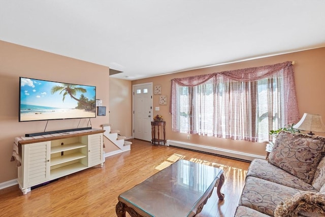 living room featuring baseboard heating and light hardwood / wood-style flooring