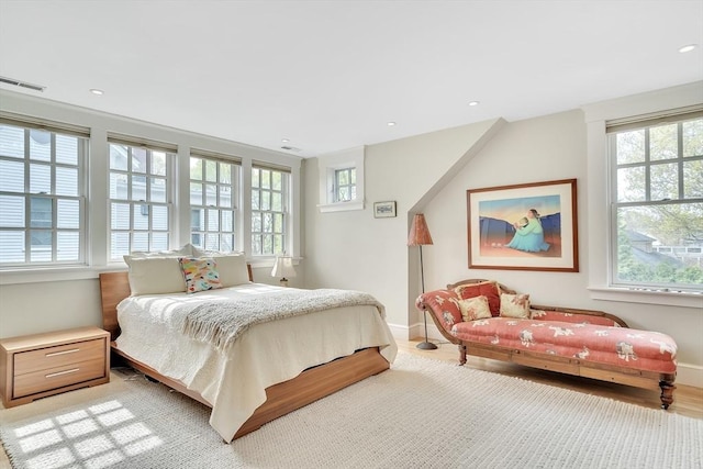 bedroom featuring baseboards, multiple windows, and visible vents
