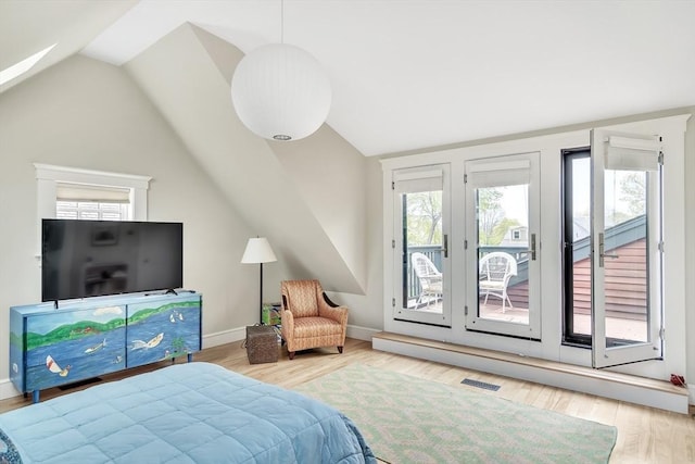 bedroom with visible vents, wood finished floors, lofted ceiling, access to exterior, and baseboards